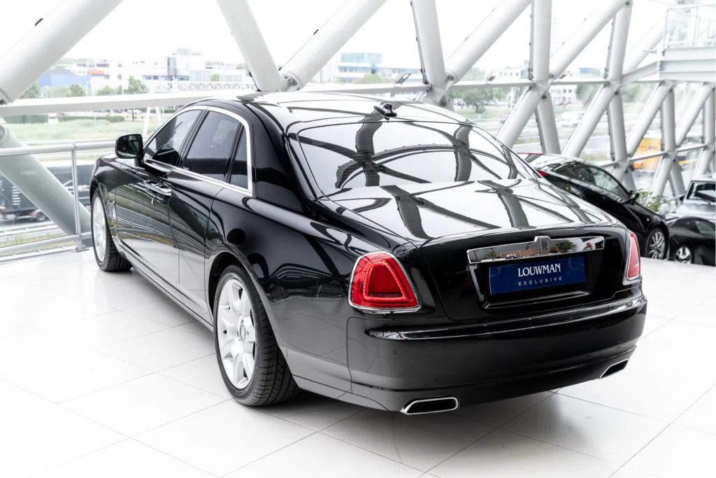 2010 Rolls-Royce Ghost, rear three-quarter view, Black