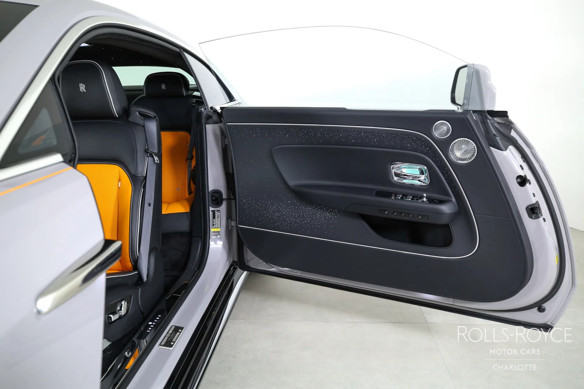 2024 Rolls-Royce Spectre interior, door panel, Black/Mandarin/Cashmere Grey